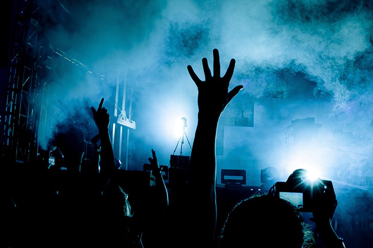 Crowd silhouetted against stage lighting at a music festival